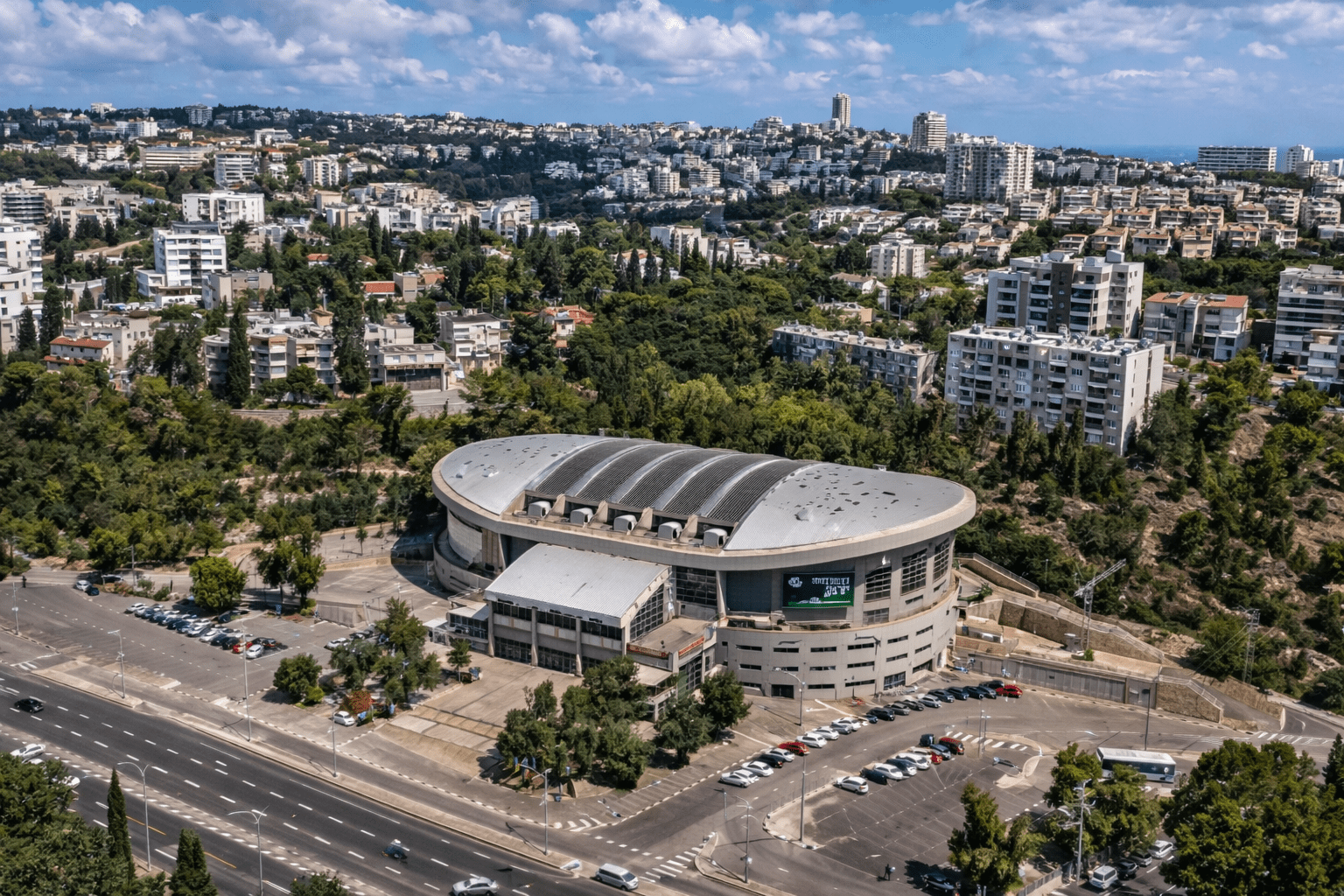 כיכר מרכזית בשכונת רוממה בחיפה עם בנייני מגורים וסביבה ירוקה